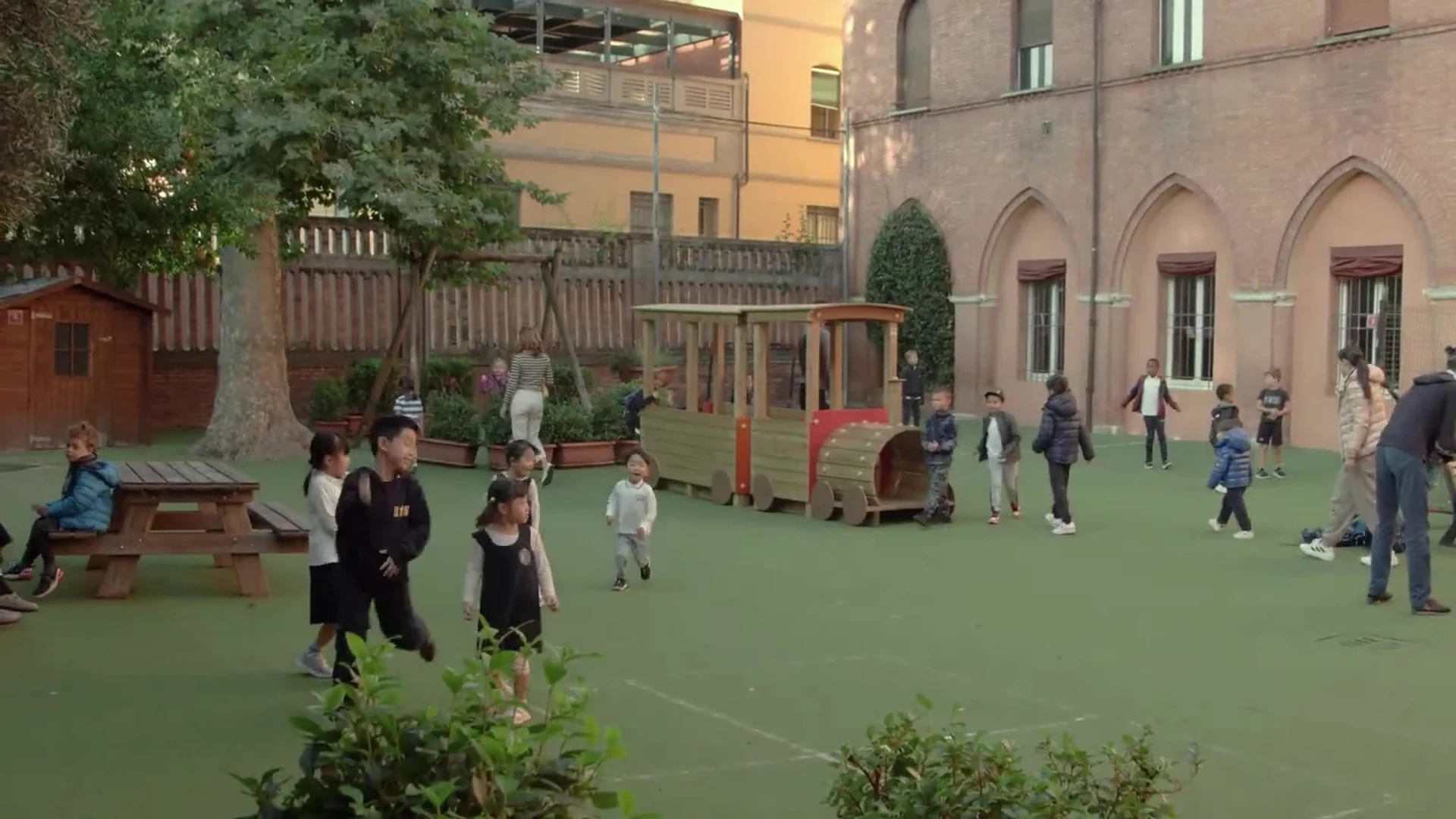 Children playing in the International School of Bologna courtyard, from the supplied school film.