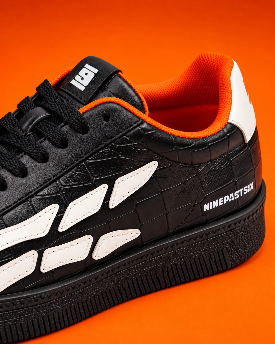 Bare-Bones sneaker with orange lining against an orange background.